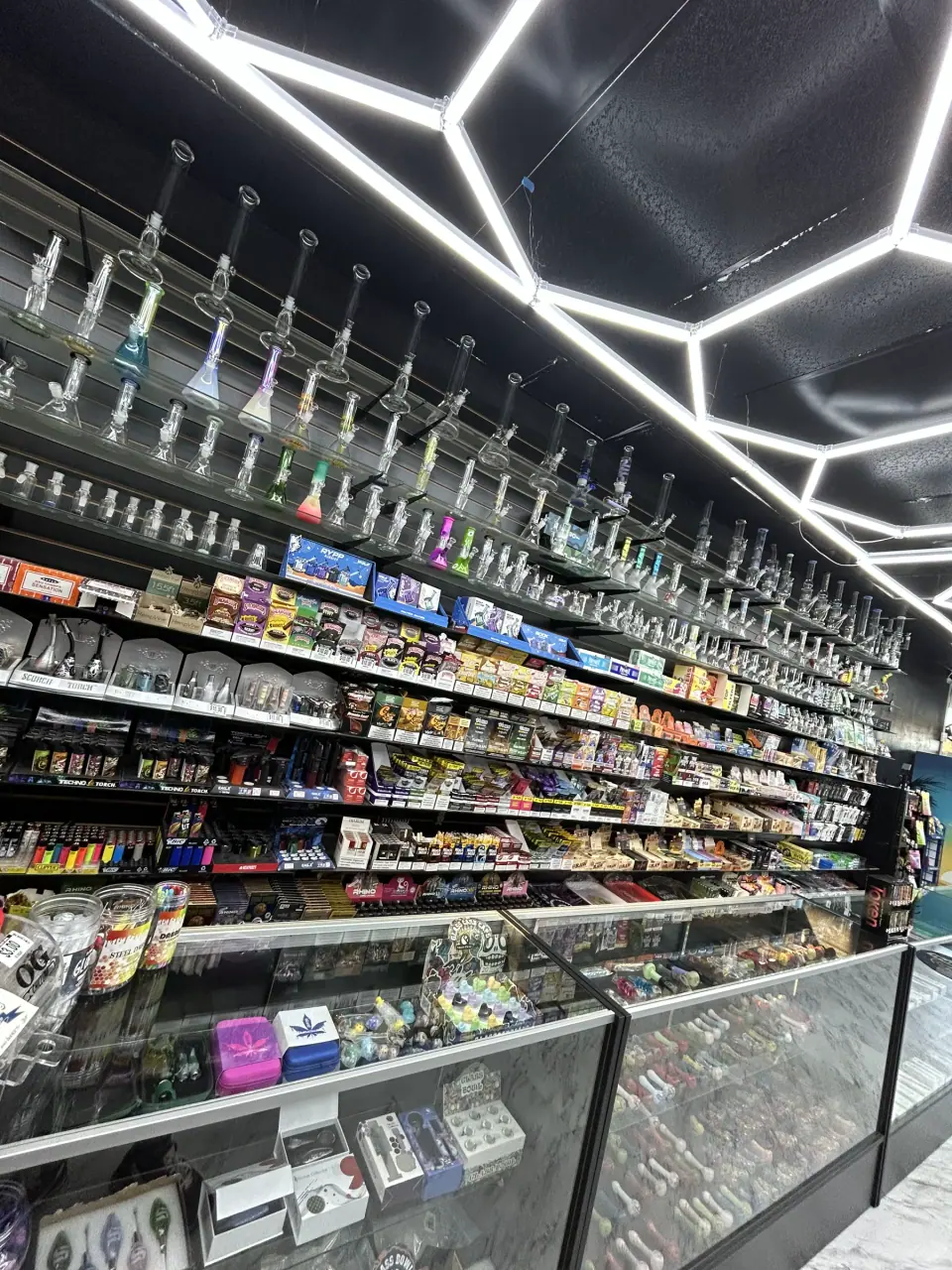Glassware, grinders, bongs, and rolling accessories displayed at Imperial Beach Smoke and Market