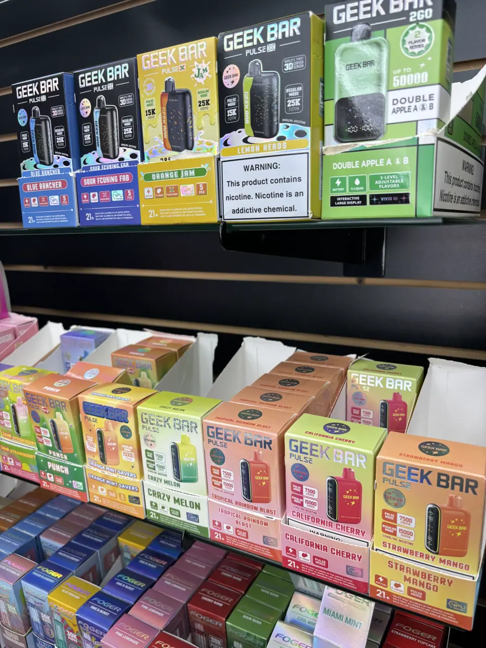 Geek Bar disposable vapes in assorted flavors displayed in the shop