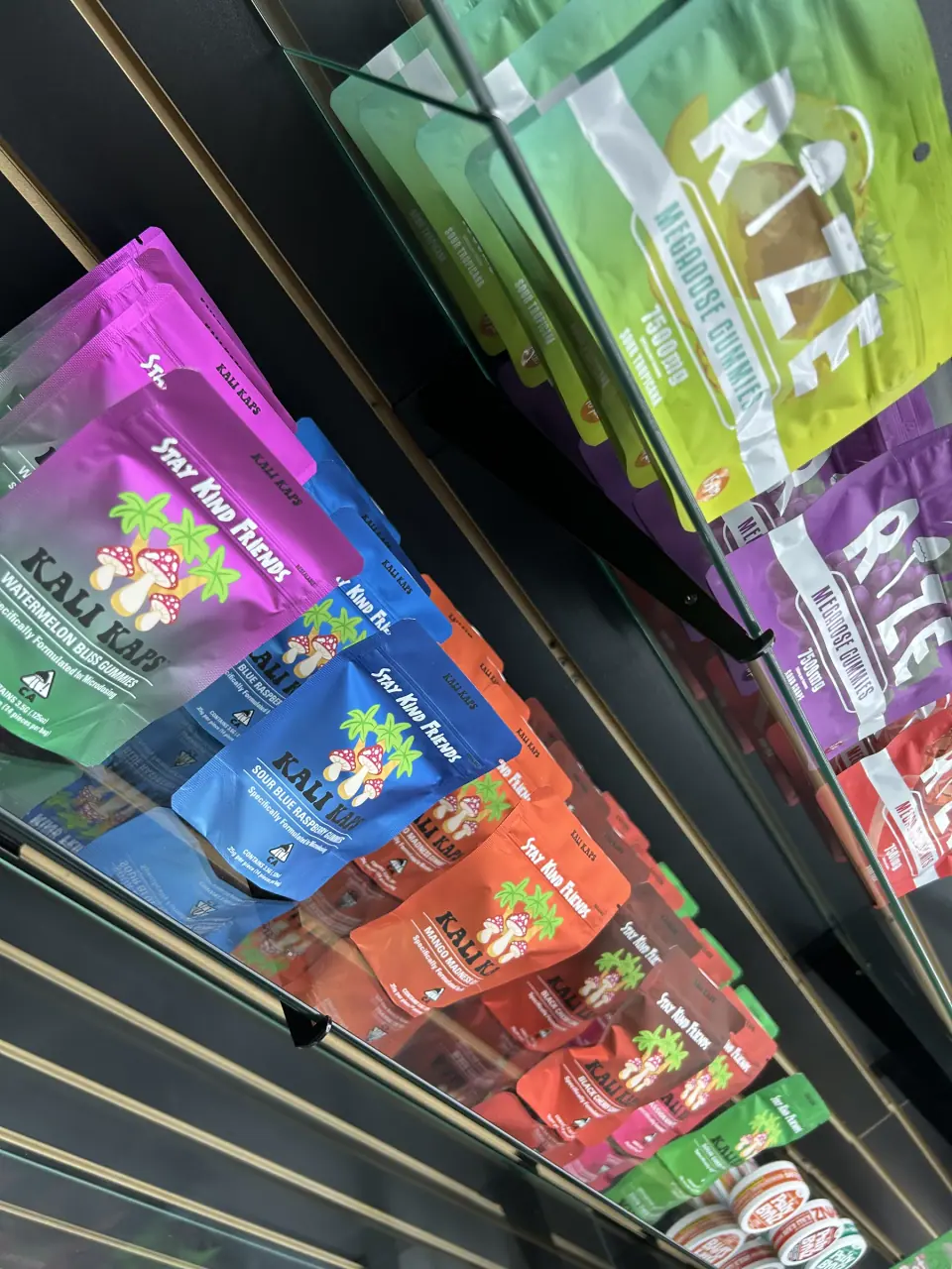 Colorful mushroom gummy pouches displayed at Imperial Beach Smoke and Market