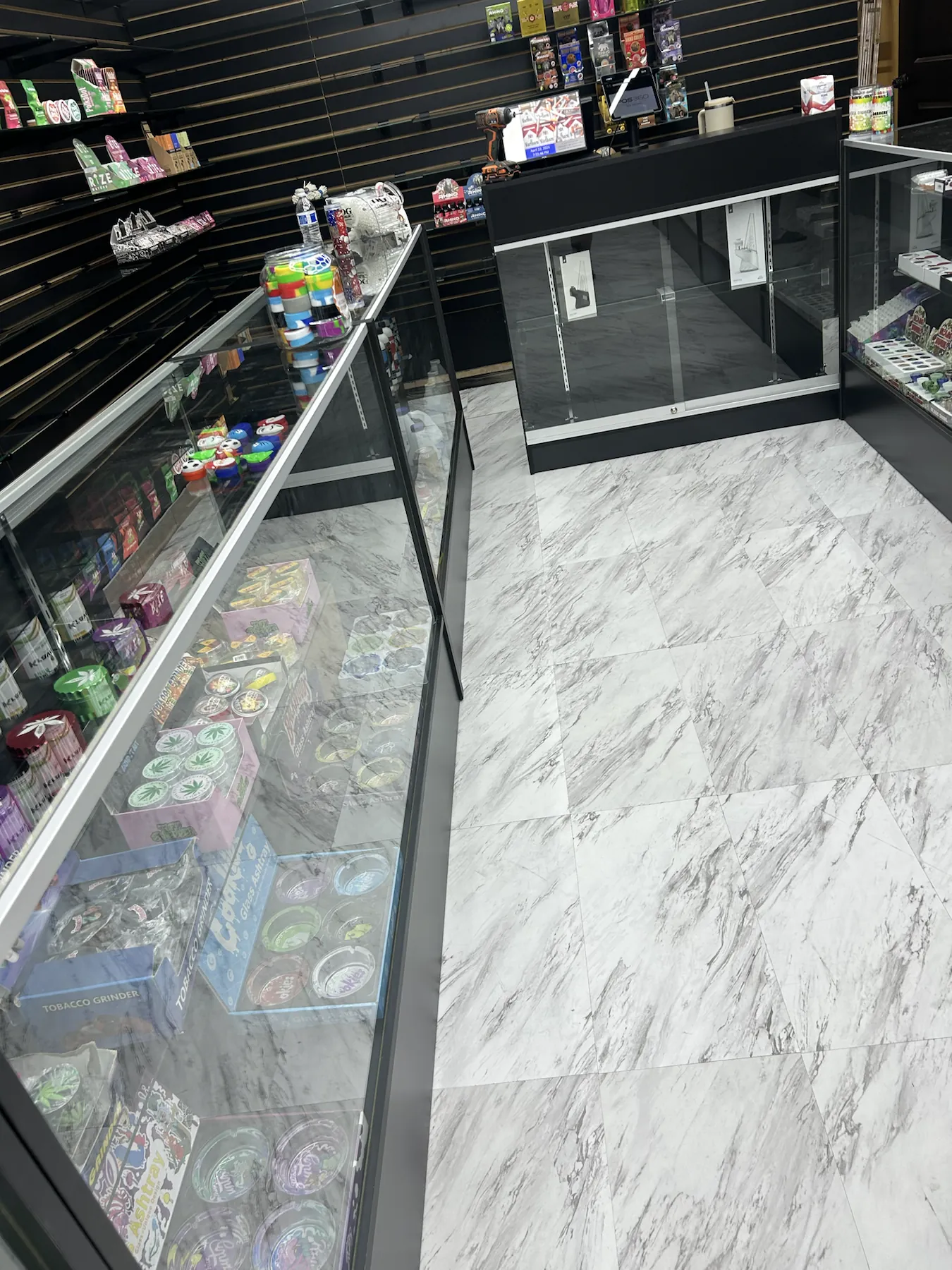 Glass display counters and product shelves inside the local smoke shop